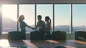 business people shaking hands consultant greeting international clients with handshake planning partnership deal female executive meeting shareholders in corporate office at sunset - Powered by Shutterstock - Get 15% off with code: PIKWIZARD15