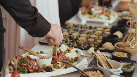 Delicious snacks and appetizers on feast table.  Party celebration, wedding concept.  Restaurant catering  with canapes  at a buffet.
