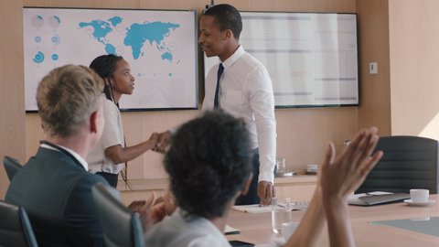 business people celebrating victory team leader man congratulating female executive for successful sales company shareholders clapping hands in office boardroom meeting