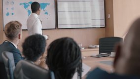 Black businessman presenting financial data on tv screen sharing project with shareholders team leader briefing colleagues discussing company growth ideas in office boardroom presentation - Powered by Shutterstock - Get 15% off with code: PIKWIZARD15
