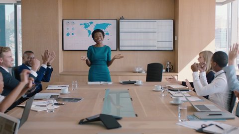 Black business woman presenting successful solution to shareholders celebrating with applause congratulating female executive for growth in sales clapping hands in office boardroom meeting