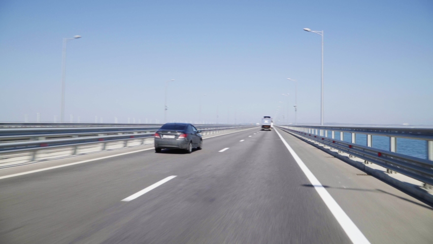 At high speed, traffic along the bridge along the sea. Highway. | Shutterstock HD Video #1034483615