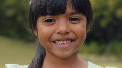 portrait beautiful little girl smiling looking happy cute child having fun in sunny park outdoors enjoying childhood testimonial concept 4k footage