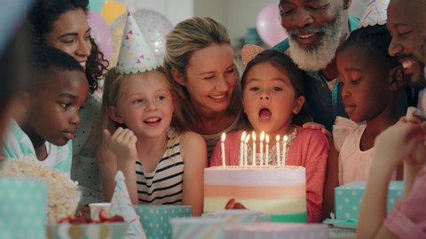 happy birthday girl blowing candles on cake making wish celebrating party with multiracial friends children having fun celebration at home 4k footage