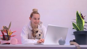 beauty caucasian woman play with jack russell terrier at table watch video on laptop work study chill relax room home loft studio office 5g social shopping think funny