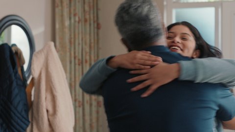 happy teenage girl hugging father congratulating daughter successful achievement excited dad feeling proud parent at home 4k