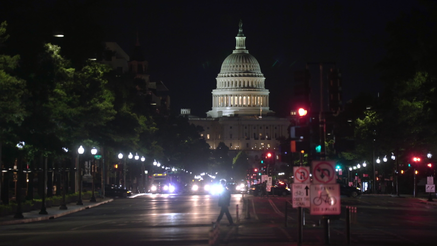 Washington DC US Capitol building looking down Pennsylvania Avenue at the illuminated Capitol hill on a summer night. 