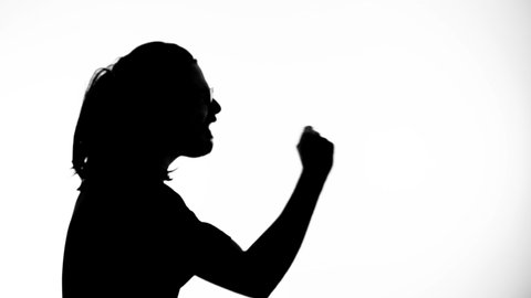 Silhouette of an aggressive man explaining himself with hand gestures