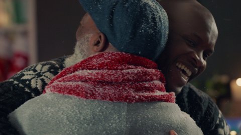african american grandparents visiting for christmas hugging family giving presents enjoying festive holiday celebration on winter evening at home 4k footage Arkivvideo