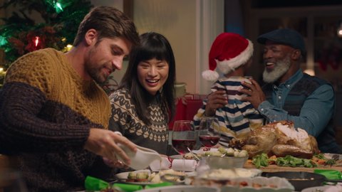 happy couple enjoying christmas dinner with friends celebrating festive holiday with family sharing evening meal at home 4k