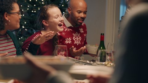happy family christmas dinner sharing delicious homemade meal at festive celebration sitting at table enjoying feast celebrating holiday at home with friends 4k footage Arkivvideo