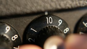 Men hand turning the volume knob on guitar amplifier - Powered by Shutterstock - Get 15% off with code: PIKWIZARD15