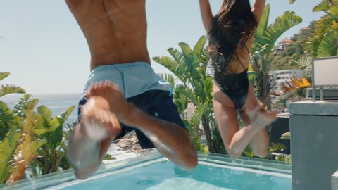 fun friends jumping in swimming pool at luxury hotel resort celebrating summer vacation enjoying sunny day on travel holiday 4k