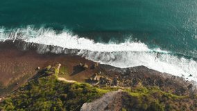 Aerial view of cliff and ocean with waves