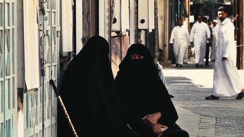 Asir Province / Saudi Arabia - 03 09 2015: Two women wearing burka sitting outside talking in Asir Province, 