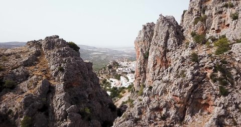 High quality drone video in 4k. Aerial view of Zuheros, Cordoba, Spain. You can see the village and the castle between the mountains.