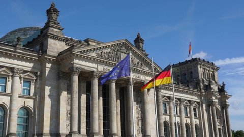 Berlin , Brandenburg / Germany - 07 19 2019: Flags in the wind at the Reichstag Building in Berlin
