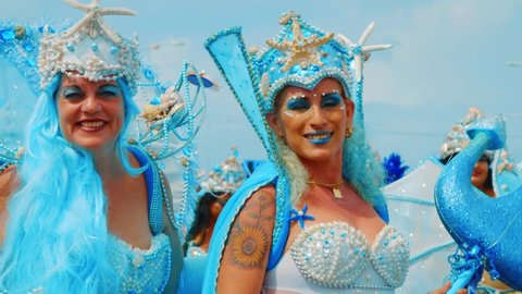 Willemstad / Curaçao - 03 03 2019: Two women in blue mermaid costumes dance for the camera at the Curacao Carnival Gran Marcha, Slow Motion Close Up.