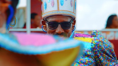 Willemstad / Curaçao - 03 03 2019: Slow motion close up shot of a charismatic smiling man in a fairy king costume marching in the Curacao Carnival Gran Marcha parade.