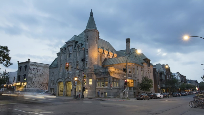 Montreal / Canada - 07 06 2019: Wide view of the fire station of St-Laurent in Montreal. Day to night timelapse with zoom in. Lot of traffic on the boulevard.