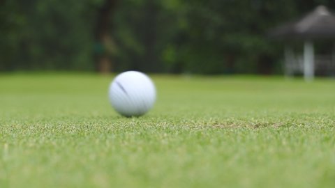 Slow Motion Golf Ball Falls Into The Hole Close Up