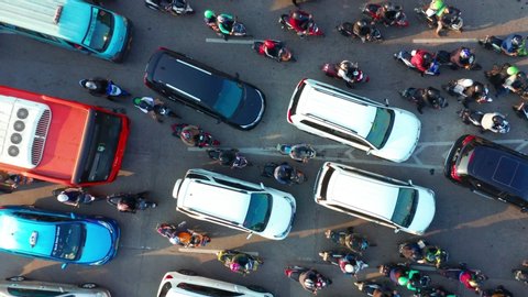 JAKARTA, Indonesia - July 30, 2019: Top down view cars and motorcycle moving on traffic jam at rush hour in Jakarta city. Shot in 4k resolution from a drone flying upwards