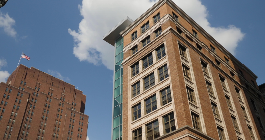 A daytime exterior establishing shot of tall buildings in downtown Pittsburgh, Pennsylvania.  	