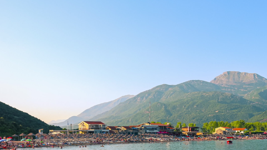Jaz beach surrounded by mountains on the Adriatic sea coast, Montenegro, time lapse panoramic motion