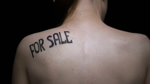 Trembling naked girl showing for sale phrase on shoulder, illegal sex industry
