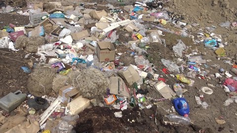 Ukraine, Odessa region - June 10, 2019:  Plastic, polyethylene and glass trash in the wild, environmental pollution, environmental disaster, the destruction of nature