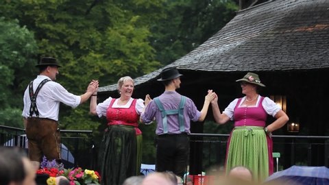 Munich , Bavaria / Germany - 07 21 2019: "Kocherlball" bavarian folk dancing event in heavy rain