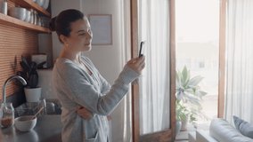 happy woman having video chat using smartphone at home chatting to friend enjoying conversation sharing lifestyle on mobile phone