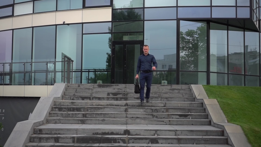The guy goes down the stairs after working day.