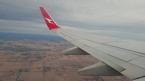 HAMILTON ISLAND, AUSTRALIA - APRIL 2019: Qantas flight over Melbourne Australia shot