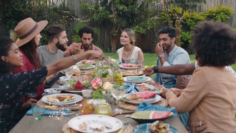 happy group of friends celebrating garden party lunch having fun chatting sharing healthy food enjoying weekend reunion relaxing on beautiful summer day outdoors 4k