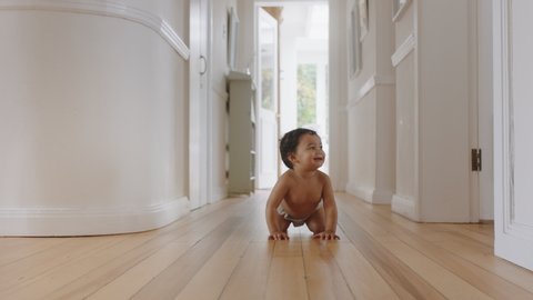 happy baby girl crawling on floor toddler exploring home curious infant having fun enjoying childhood