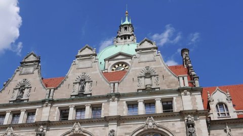 Time lapse of looking up at the facade of the New Town Hall in Hannover, Germany with moving clouds
