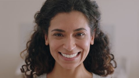 portrait beautiful mixed race woman smiling 30's looking up at camera with happy emotion enjoying successful lifestyle