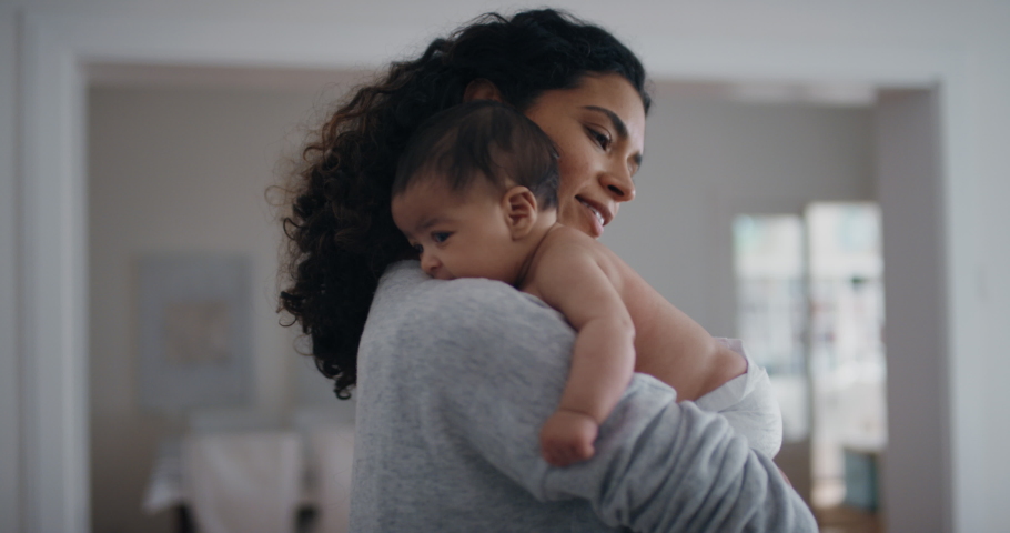 Happy mother holding baby calming her newborn child mom gently soothing infant enjoying nurturing motherhood at home 4k | Shutterstock HD Video #1034552960