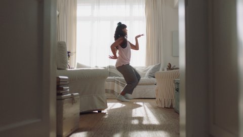 happy young woman dancing at home having fun celebrating with funny dance moves enjoying freedom on weekend morning 4k footage