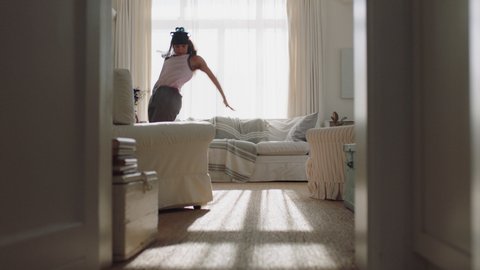 happy young woman dancing at home having fun celebrating with funny dance moves enjoying freedom on weekend morning 4k footage