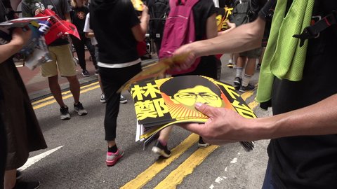 HONG KONG – 1 JULY 2019: Distributing flyers calling for Hong Kong chief executive Carrie Lam to resign after extradition bill was suspended