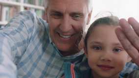 grandfather and child having video chat little girl sharing vacation weekend with family grandpa enjoying chatting on mobile technology at home with granddaughter pov 4k