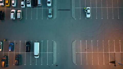 Top view of the parking lot and shopping center. Car Park Night Aerial Vertical View