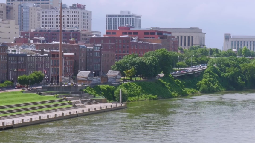 Panning shot of Boat speeding down Cumberland River in Nashville, Tennessee
