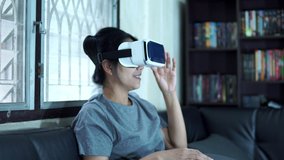 Asian girl watching a three-dimensional video through fun glasses at home