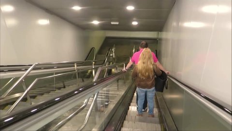 Malaga / Spain - 06 03 2019: People on down escalator at local commuter service railway station