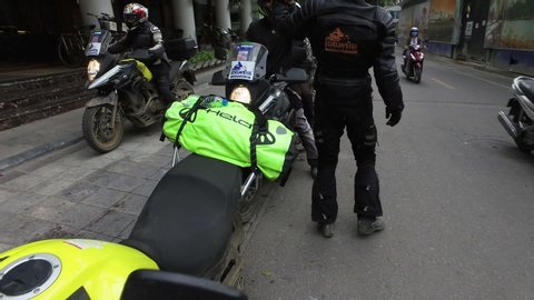 Ha Noi / Vietnam - 11 14 2018: Ha Noi, Vietnam, 11.14.2018 -biker saluting his friends on parked motorbikes. Ha Noi Vietnam