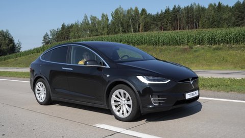 MINSK, BELARUS - JULY 24, 2019: Smooth footage of electric emission free SUV Tesla Model X 100D drives on a highway.  Version 100D  accelerates from zero to 60 miles per hour in 4.4 seconds.