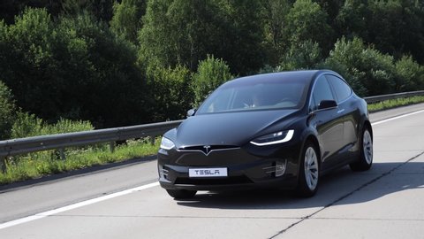 MINSK, BELARUS - JULY 24, 2019: Smooth footage of electric emission free SUV Tesla Model X 100D drives on a highway.  Version 100D  accelerates from zero to 60 miles per hour in 4.4 seconds.